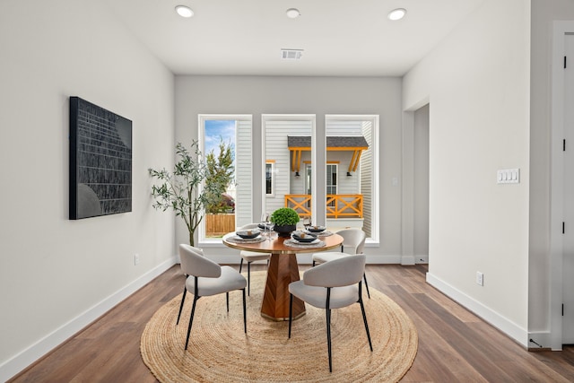 dining space with visible vents, recessed lighting, baseboards, and wood finished floors