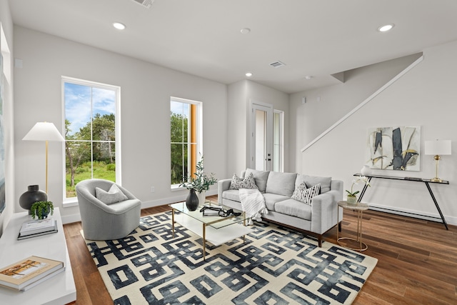 living room featuring recessed lighting, baseboards, and wood finished floors