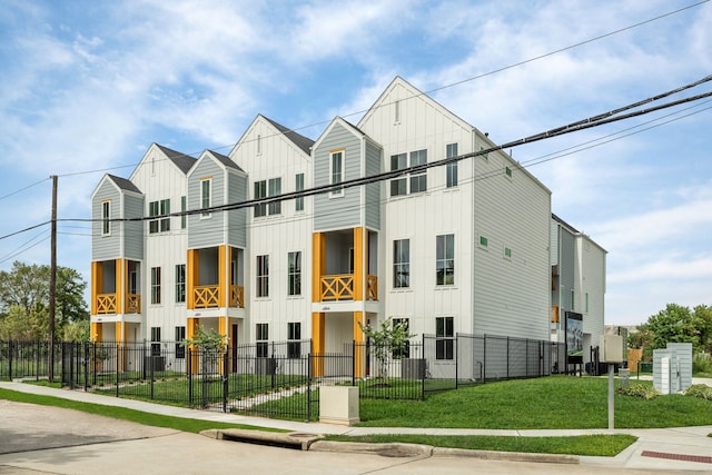view of building exterior with a fenced front yard
