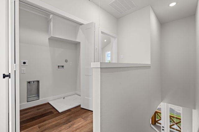 laundry area with laundry area, electric dryer hookup, visible vents, wood finished floors, and hookup for a washing machine
