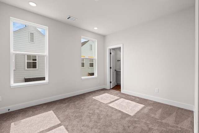 unfurnished bedroom with carpet floors, baseboards, recessed lighting, and visible vents