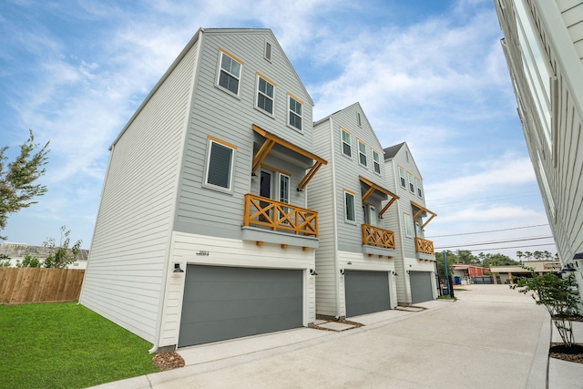 exterior space featuring a garage, fence, and driveway
