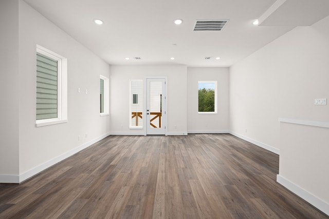 empty room with recessed lighting, baseboards, visible vents, and dark wood finished floors
