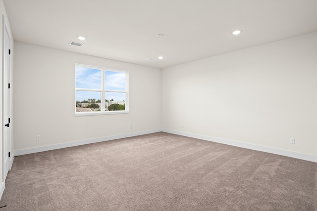 carpeted empty room featuring recessed lighting, baseboards, and visible vents