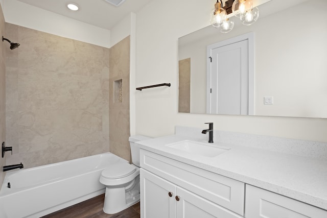 bathroom featuring vanity, shower / bathtub combination, wood finished floors, and toilet