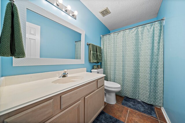 17203 Meadow Heights Dr, Houston, TX 77095 - bathroom featuring a textured ceiling, vanity, tile patterned flooring, visible vents, and toilet