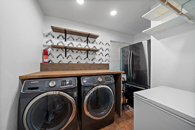 17203 Meadow Heights Dr, Houston, TX 77095 - clothes washing area featuring washer and dryer, laundry area, and dark tile patterned flooring