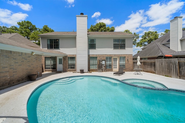 17203 Meadow Heights Dr, Houston, TX 77095 - rear view of property with a patio area, a pool with connected hot tub, fence, and a chimney