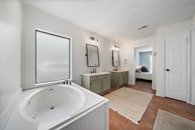 17203 Meadow Heights Dr, Houston, TX 77095 - bathroom with connected bathroom, a textured ceiling, vanity, a tub with jets, and visible vents