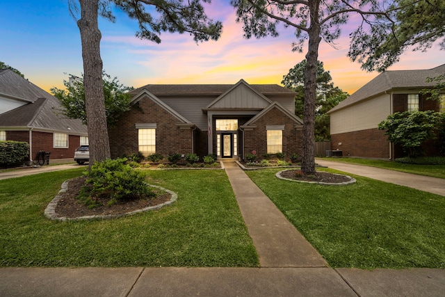 17203 Meadow Heights Dr, Houston, TX 77095 - traditional-style house with a front yard, brick siding, central AC, and board and batten siding