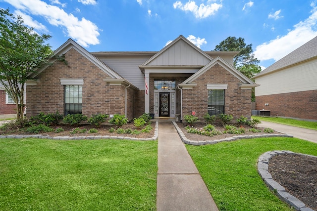 17203 Meadow Heights Dr, Houston, TX 77095 - view of front of home with board and batten siding, a front lawn, and brick siding