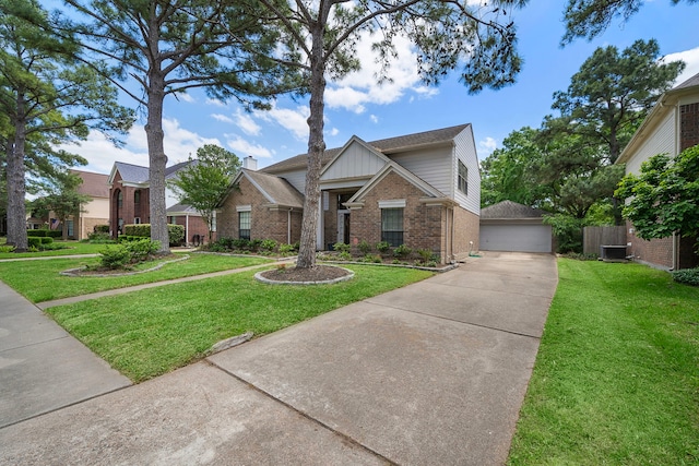 17203 Meadow Heights Dr, Houston, TX 77095 - view of front of property featuring a garage, an outdoor structure, cooling unit, brick siding, and a front lawn