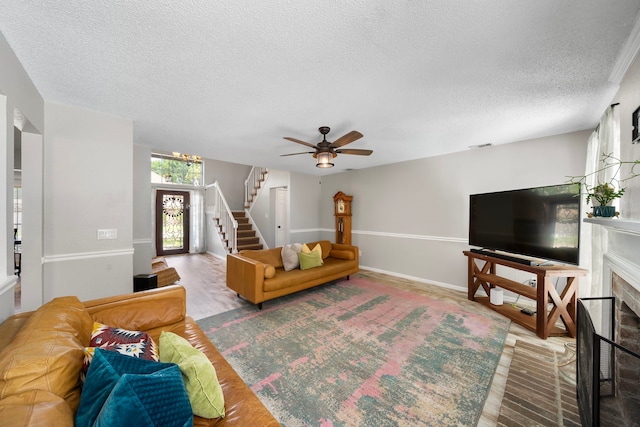 17203 Meadow Heights Dr, Houston, TX 77095 - living area featuring a textured ceiling, stairway, wood finished floors, and a fireplace