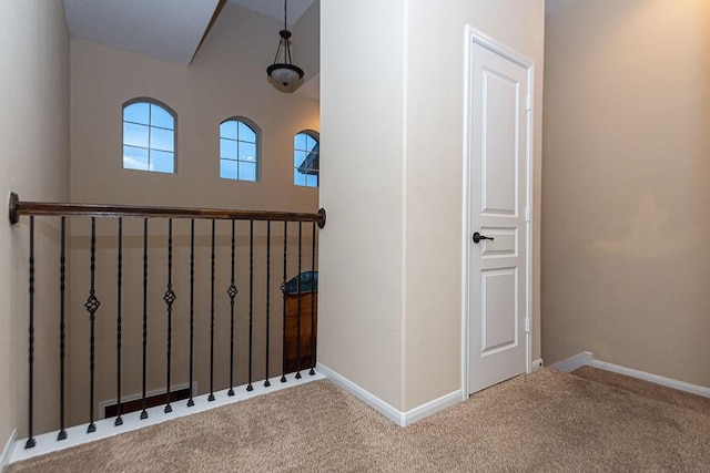 interior space with baseboards and carpet