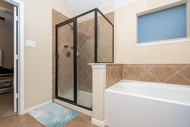 full bath with a bath, a stall shower, and tile patterned flooring
