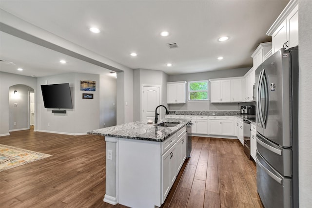 30000 Round Up Dr, Waller, TX 77484 - kitchen with a sink, appliances with stainless steel finishes, arched walkways, and dark wood finished floors