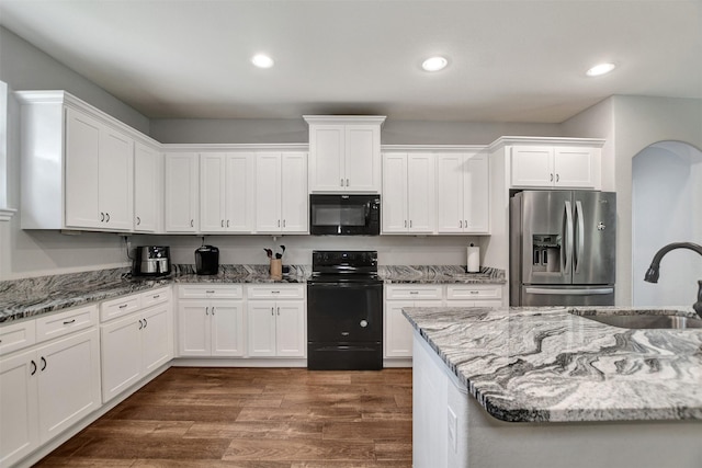 30000 Round Up Dr, Waller, TX 77484 - kitchen with a sink, black appliances, white cabinetry, and light stone countertops