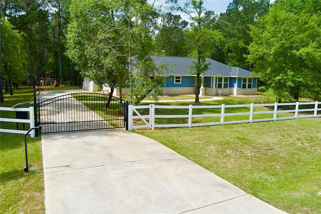 30000 Round Up Dr, Waller, TX 77484 - view of front of house featuring a fenced front yard, a gate, driveway, a garage, and a front yard