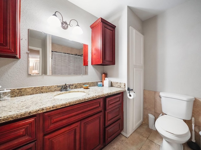 22403 Red River Dr, Katy, TX 77450 - bathroom featuring toilet, tile walls, tile patterned floors, and vanity