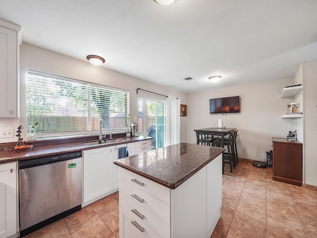 22403 Red River Dr, Katy, TX 77450 - kitchen featuring a center island, white cabinetry, visible vents, dishwasher, and a sink