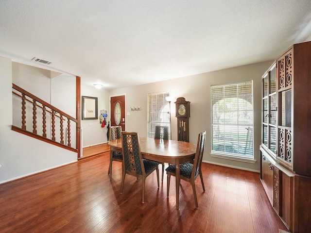 22403 Red River Dr, Katy, TX 77450 - dining area featuring stairway, dark wood-style flooring, baseboards, and visible vents