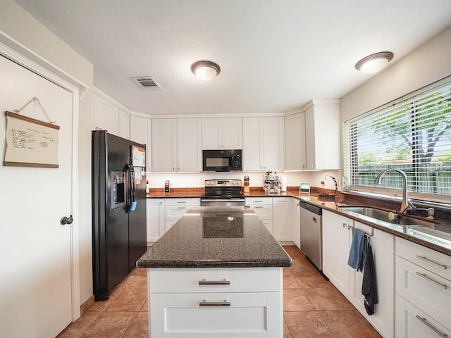 22403 Red River Dr, Katy, TX 77450 - kitchen with white cabinets, visible vents, a sink, and black appliances