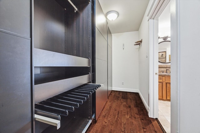 interior space with baseboards, a sink, and wood finished floors