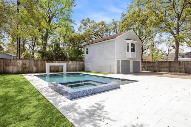 view of pool with fence, an in ground hot tub, and a lawn