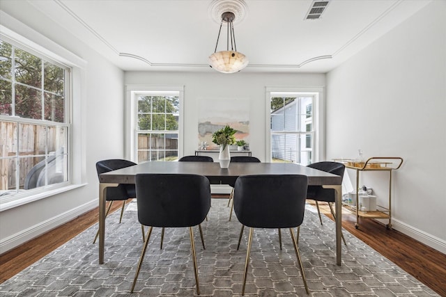 dining area featuring wood finished floors, visible vents, and plenty of natural light