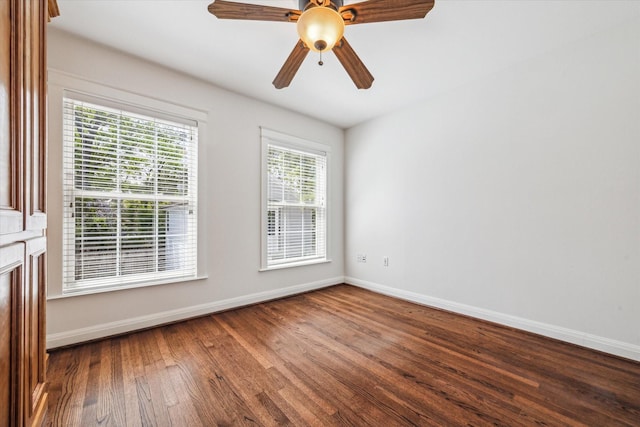 empty room featuring wood finished floors, ceiling fan, and baseboards