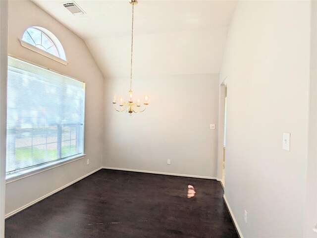 unfurnished dining area featuring dark wood-style flooring, a chandelier, baseboards, vaulted ceiling, and visible vents