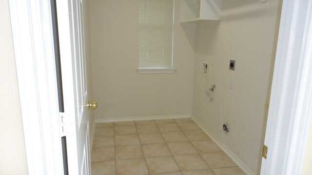 laundry area with washer hookup, laundry area, electric dryer hookup, light tile patterned floors, and baseboards