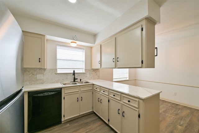 154 Camellia St, Sugar Land, TX 77478 - kitchen featuring dishwasher, freestanding refrigerator, a sink, a peninsula, and decorative backsplash