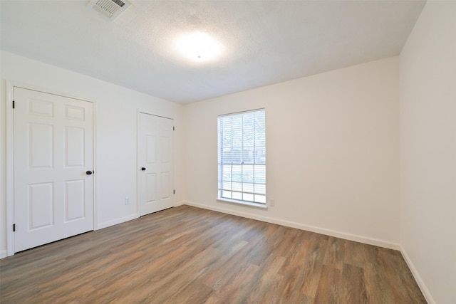 154 Camellia St, Sugar Land, TX 77478 - unfurnished bedroom featuring wood finished floors and baseboards