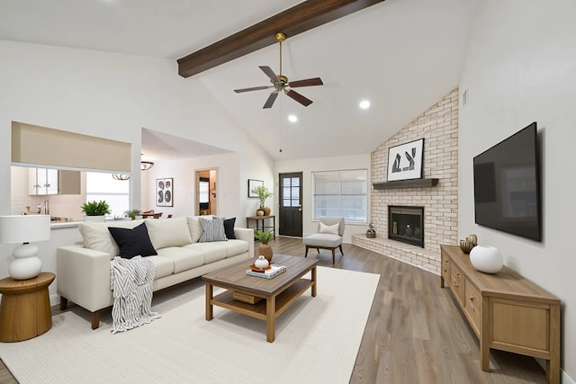 154 Camellia St, Sugar Land, TX 77478 - living area with wood finished floors, high vaulted ceiling, beamed ceiling, ceiling fan, and a fireplace