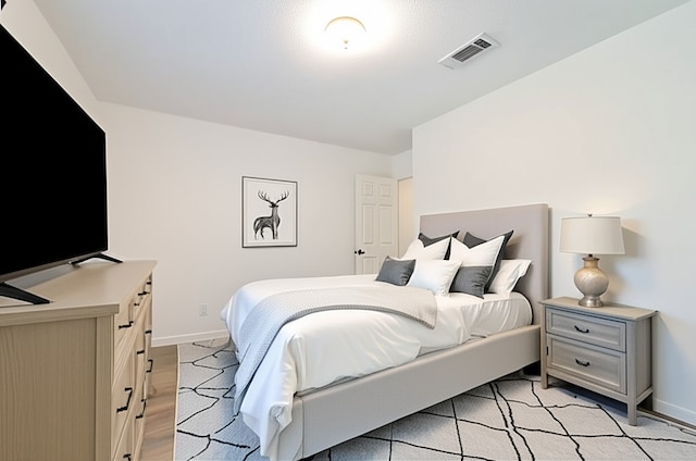 154 Camellia St, Sugar Land, TX 77478 - bedroom featuring baseboards and light wood-style floors