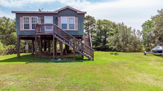 637 Troy St, Anahuac, TX 77514 - back of property featuring a lawn and stairs