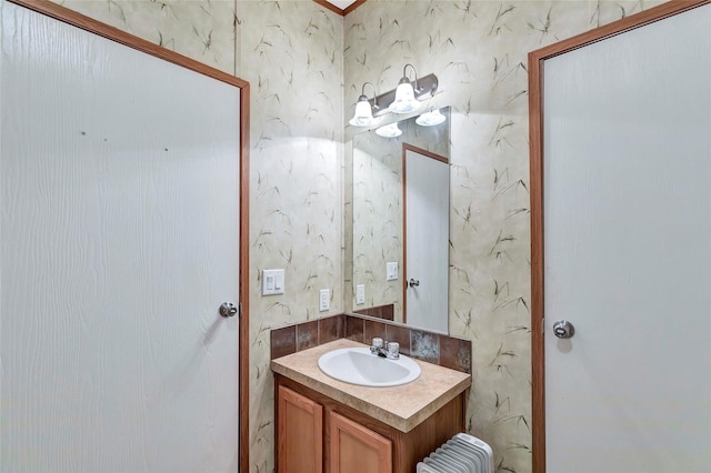 637 Troy St, Anahuac, TX 77514 - bathroom featuring wallpapered walls and vanity