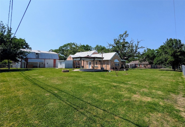 view of yard featuring a fire pit and a fenced backyard