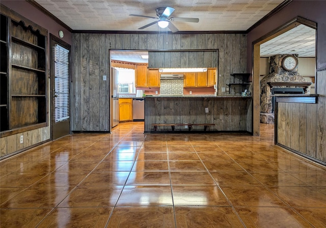 kitchen with a ceiling fan, stainless steel dishwasher, and ornamental molding