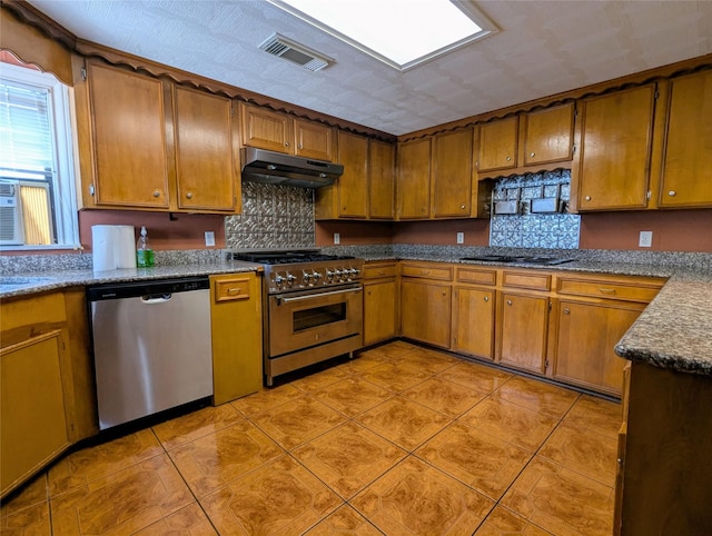 kitchen with under cabinet range hood, brown cabinetry, appliances with stainless steel finishes, and visible vents