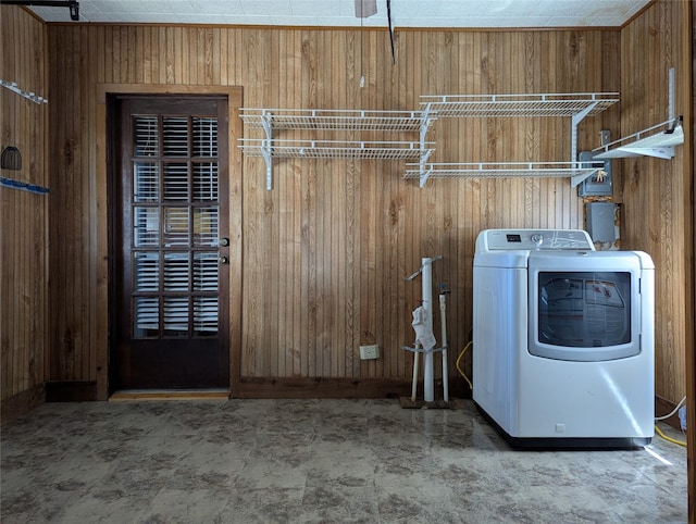 laundry room featuring wooden walls, laundry area, and washer / clothes dryer