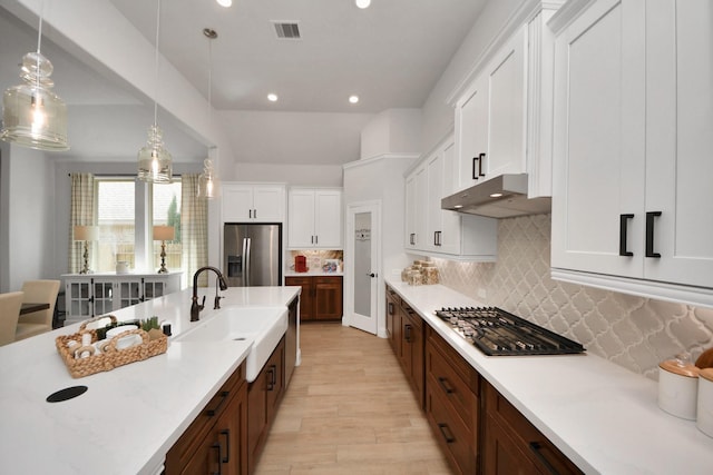19407 Sorrel Stallion Trl, Tomball, TX 77377 - kitchen with visible vents, recessed lighting, appliances with stainless steel finishes, under cabinet range hood, and light countertops
