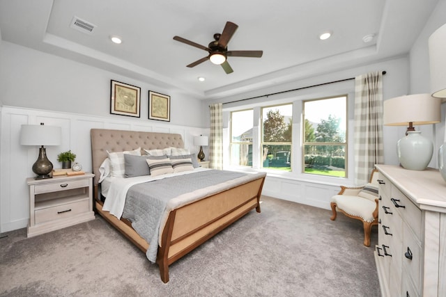 19407 Sorrel Stallion Trl, Tomball, TX 77377 - bedroom with a raised ceiling, a decorative wall, carpet flooring, and visible vents