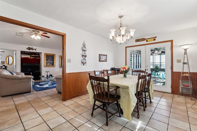 221 Kokomo Run, Point Blank, TX 77364 - dining area featuring light tile patterned flooring, wooden walls, and wainscoting
