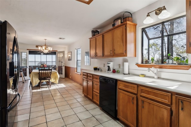 221 Kokomo Run, Point Blank, TX 77364 - kitchen featuring a chandelier, light countertops, a sink, and black appliances
