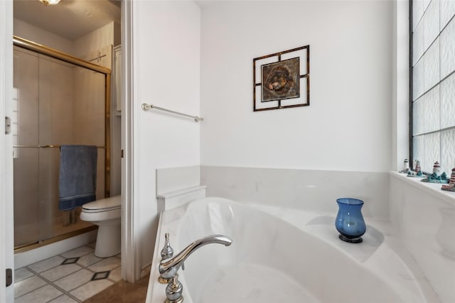 221 Kokomo Run, Point Blank, TX 77364 - full bathroom featuring a shower stall, tile patterned floors, a garden tub, and toilet