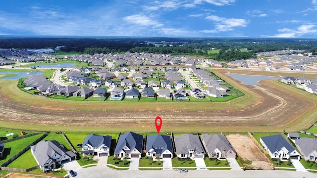 birds eye view of property with a water view and a residential view
