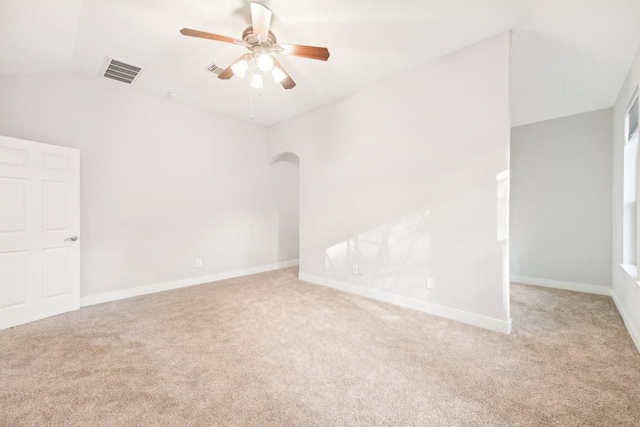 carpeted empty room with visible vents, ceiling fan, baseboards, and lofted ceiling