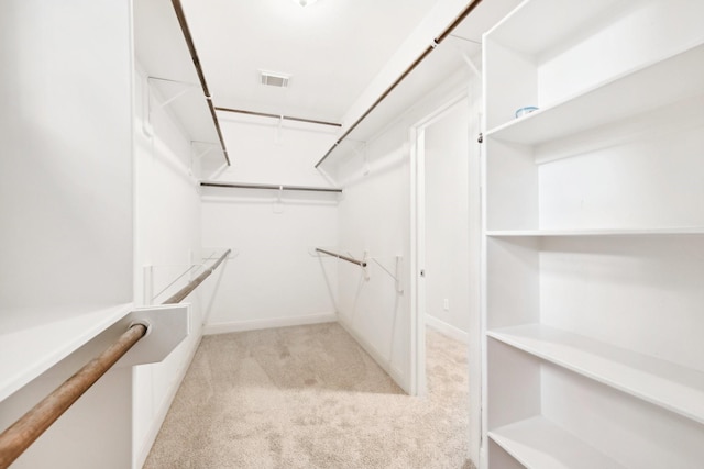 walk in closet featuring carpet and visible vents